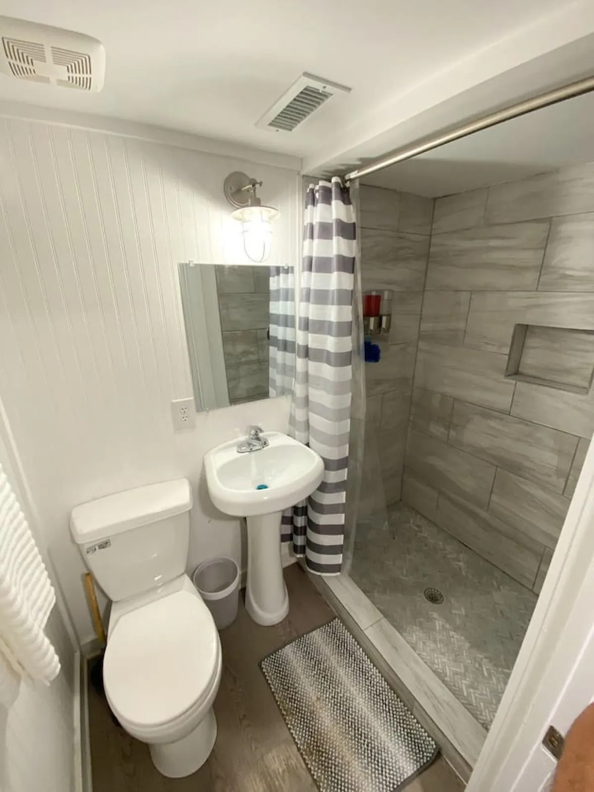 A well-appointed bathroom featuring a modern shower area, vanity with sink, and a toilet. The atmosphere is inviting and functional, with contemporary design elements that suggest comfort and cleanliness.